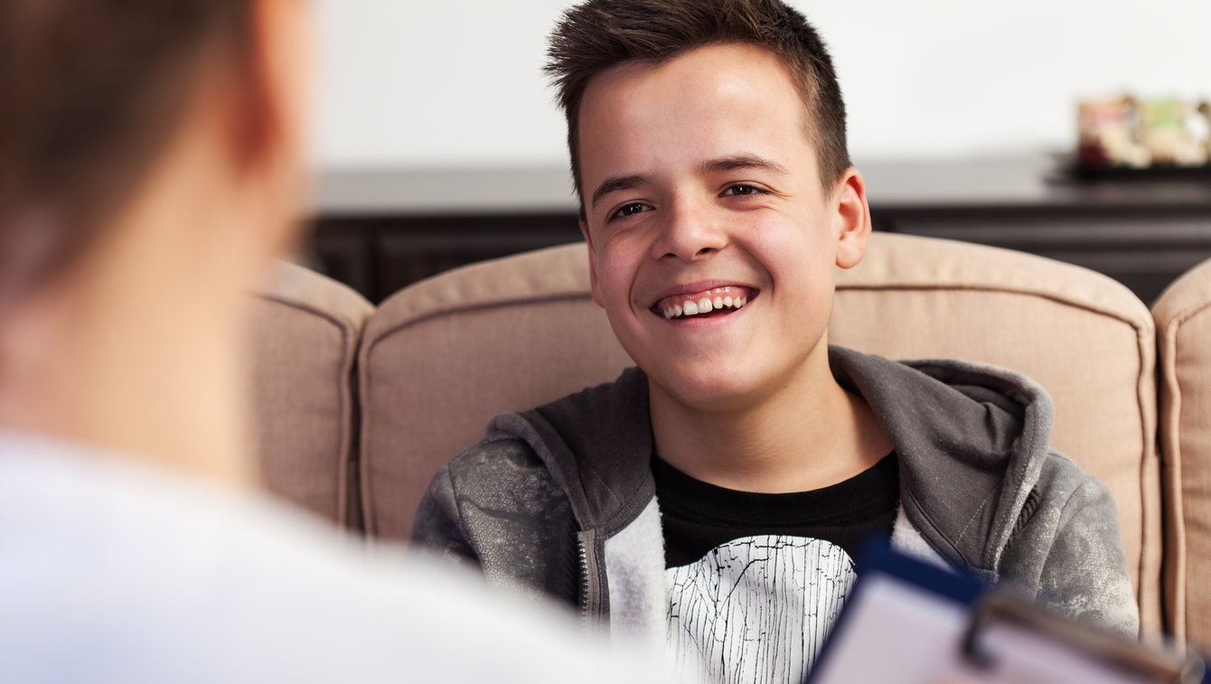 Young boy smiling at a psychiatrist