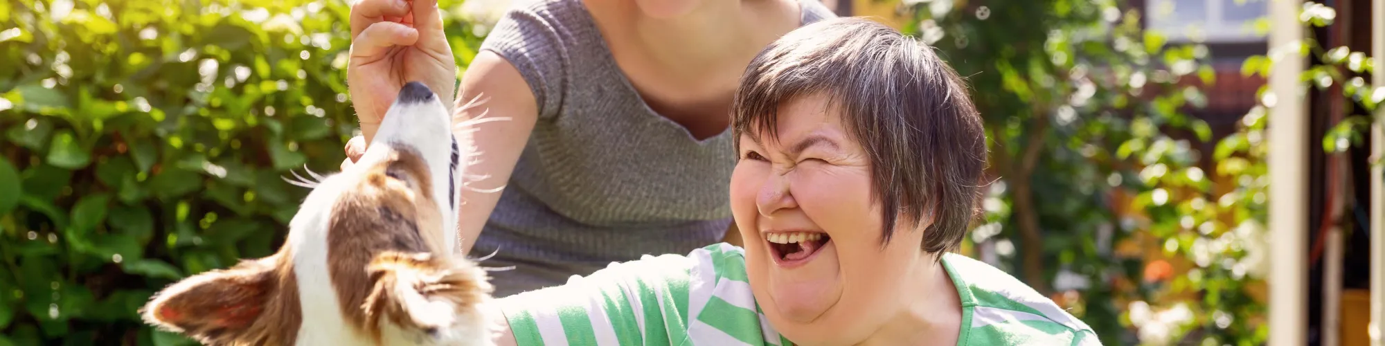 Woman giving dog a treat.