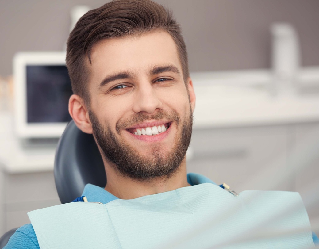Man happily smiling at dental office.