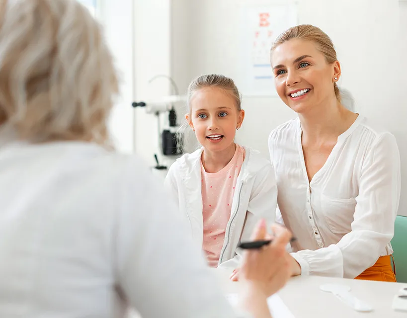 Happy mom and daughter meet with a care coordinator