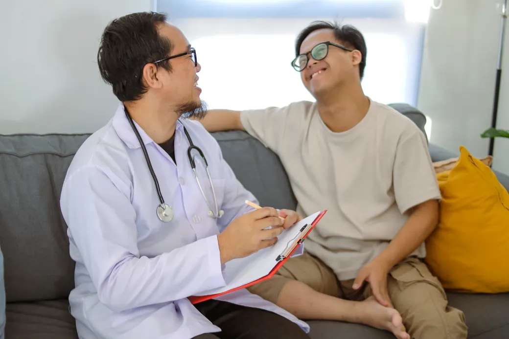 Doctor Consults with Patient with Down Syndrome