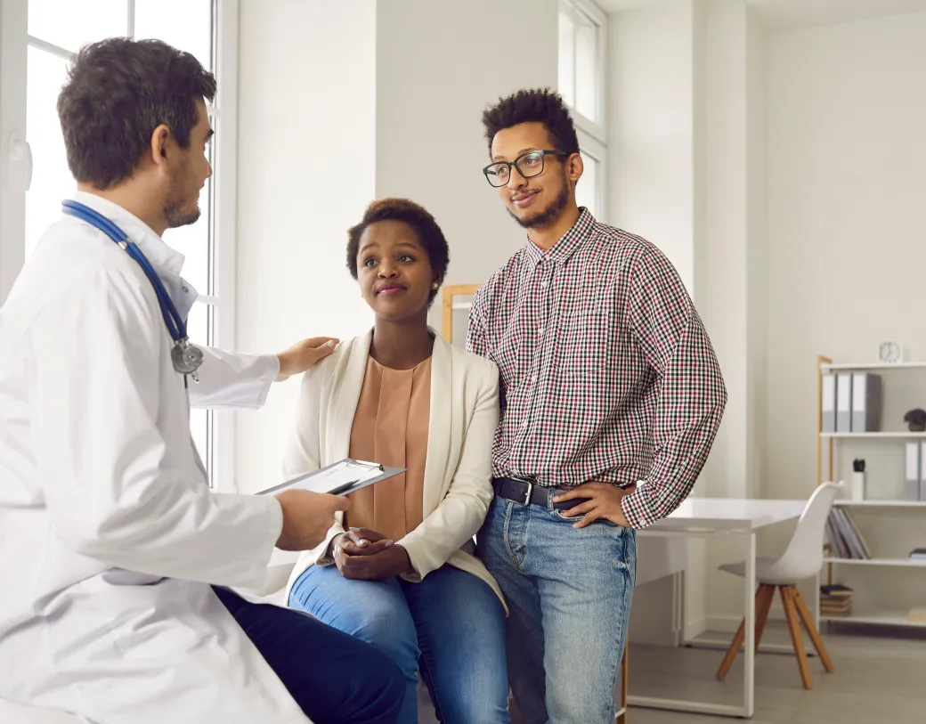 Young couple visiting doctor for professional consultation and health check up
