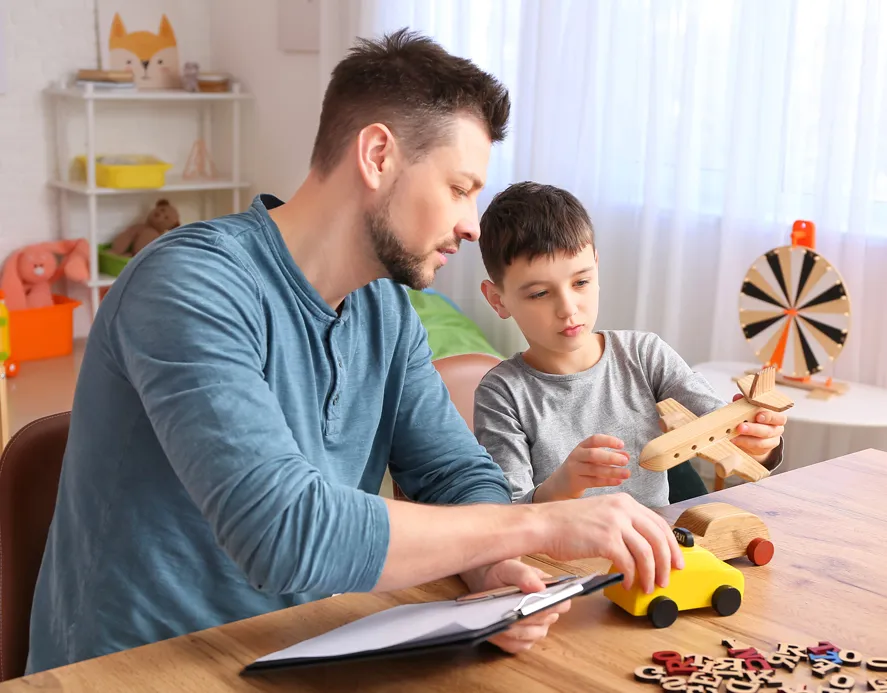Adult man with child playing with toys
