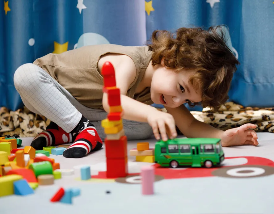 Small child playing with blocks and toys