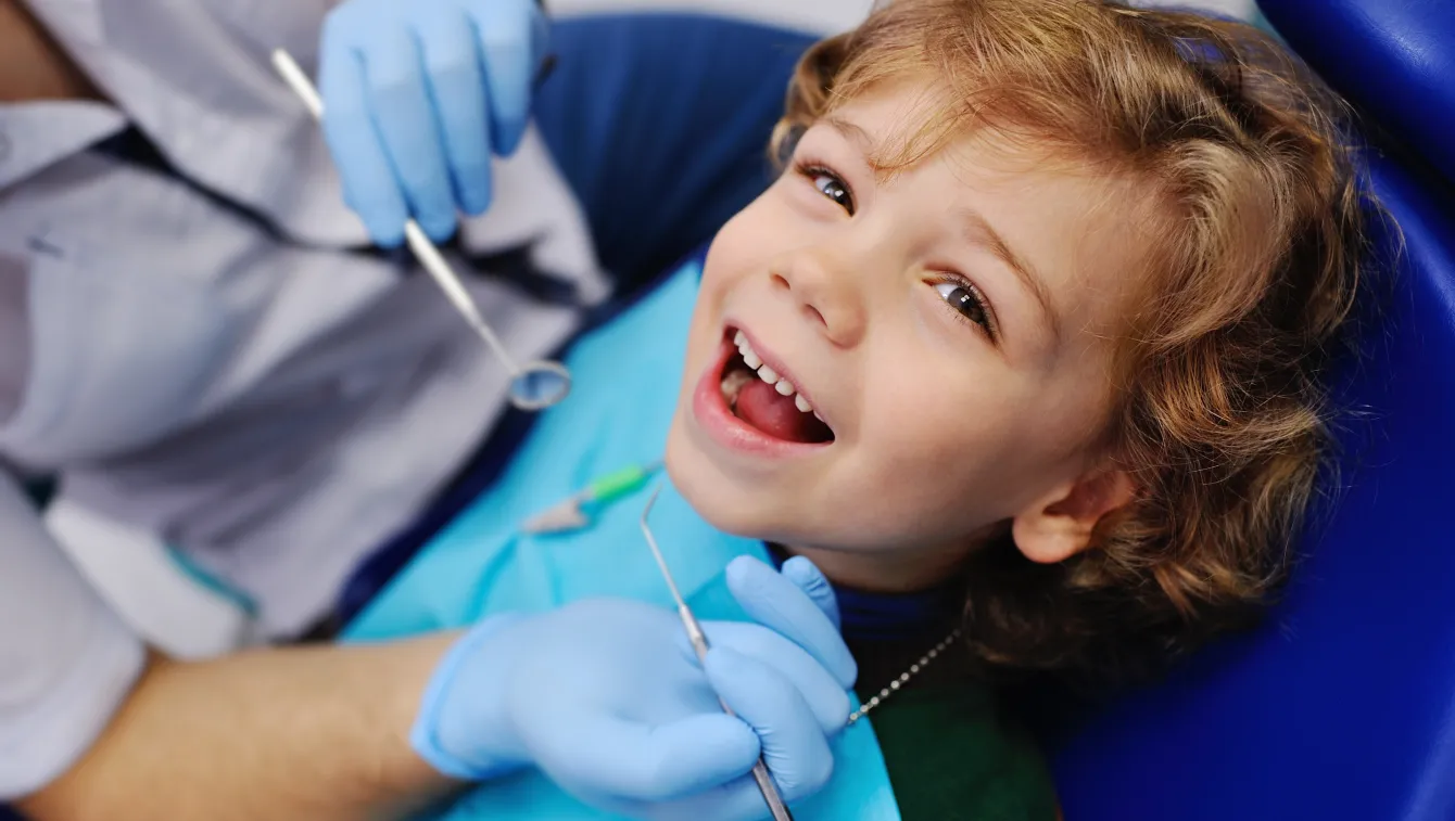 Smiling boy receiving a dental exam