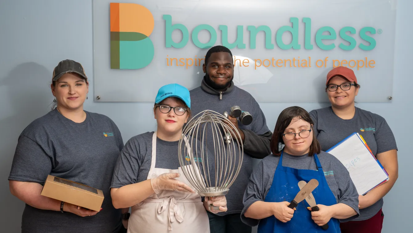 The team of Confection Connection bakers pose with their tools
