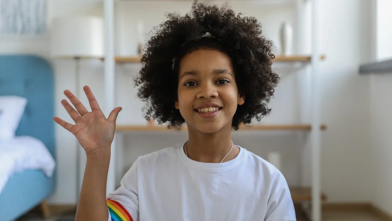 A little girl waiving