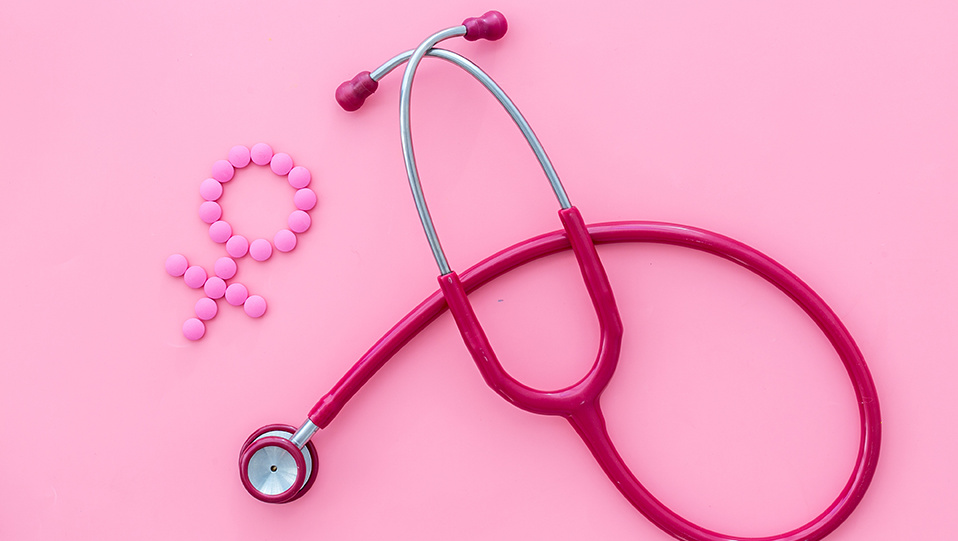  Women's Health issues. Medical concept with Venus sign and stethoscope on pink background top-down 