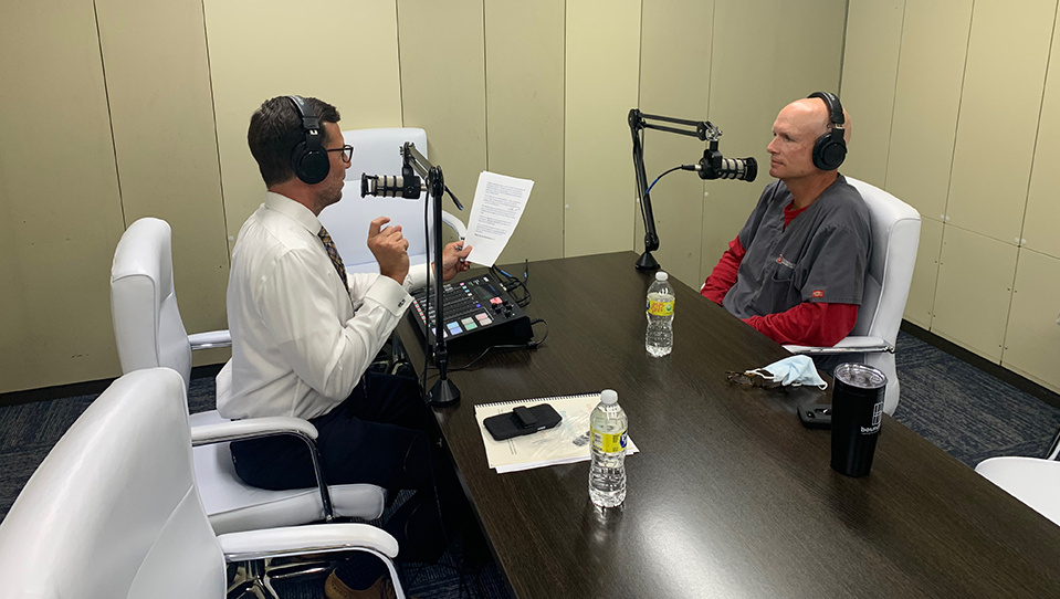 Scott light interviews Dr. Beetstra in a podcast studio
