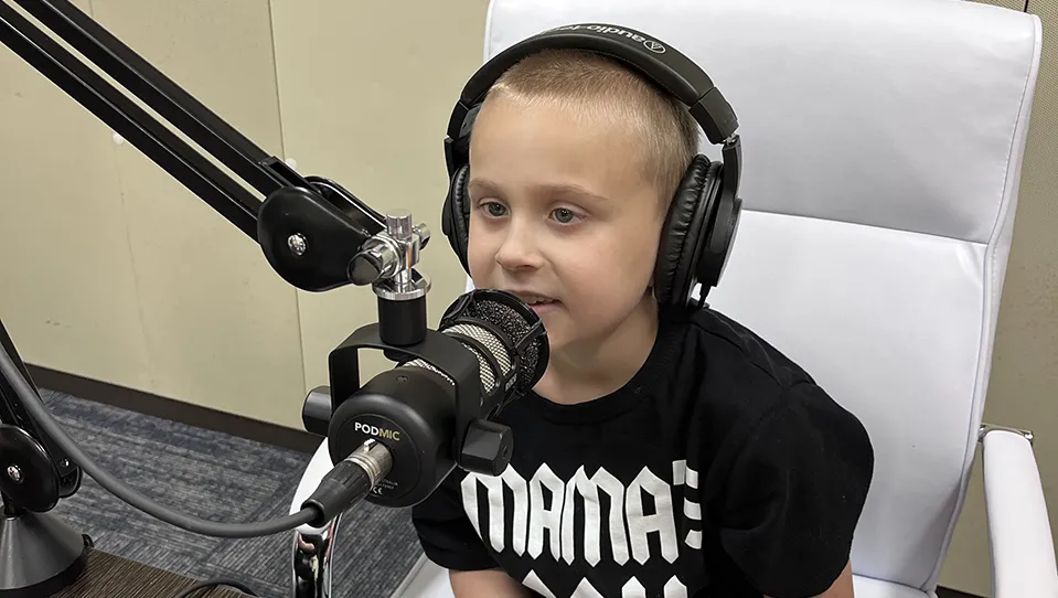 Obi speaking into a microphone 