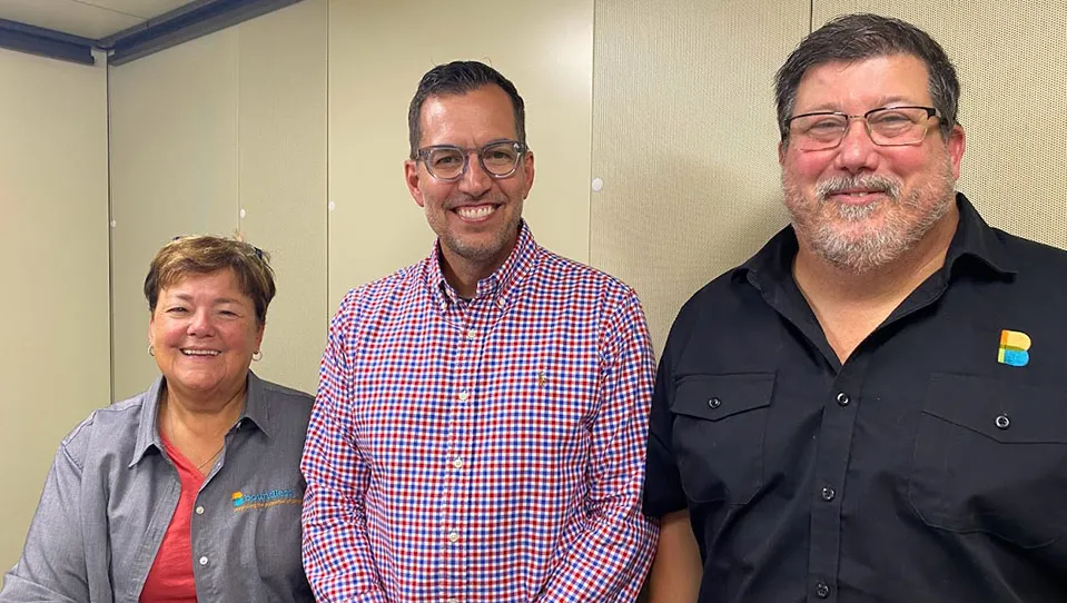 Suzie Burke, Scott Light, and Todd Mitchell smiling in the podcast studio