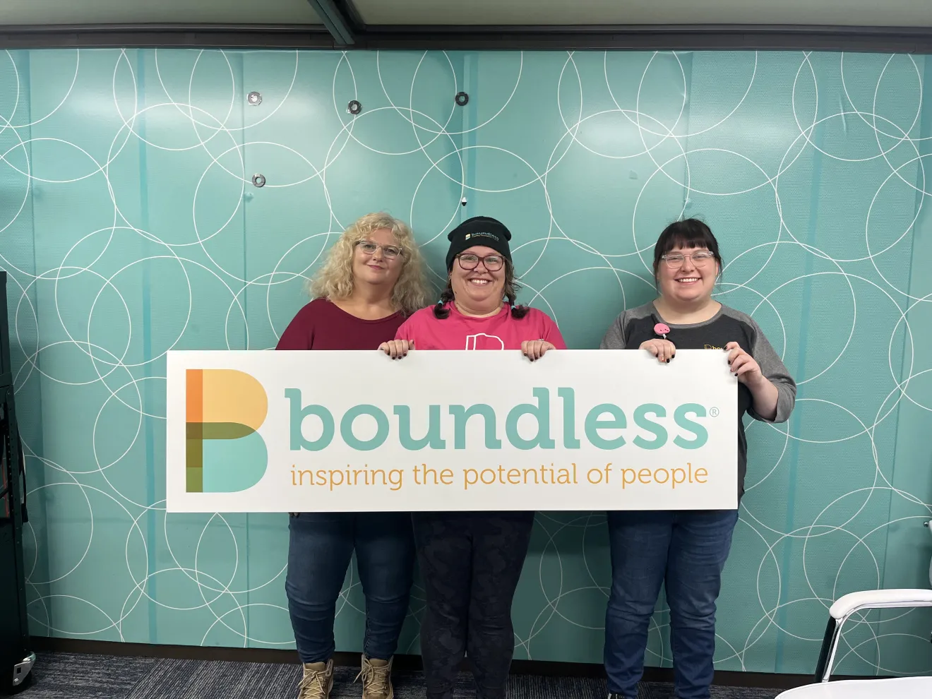 Photo of guest Janet, Kristen and Kelli holding Boundless sign