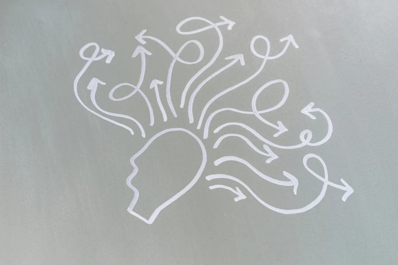 A drawing of a head with many arrows extending from it