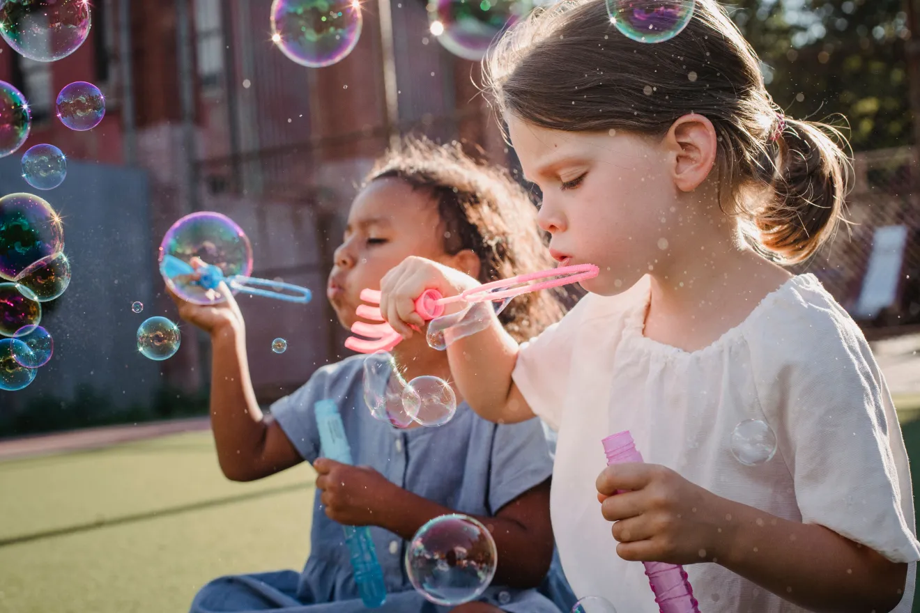 children blowing bubbles