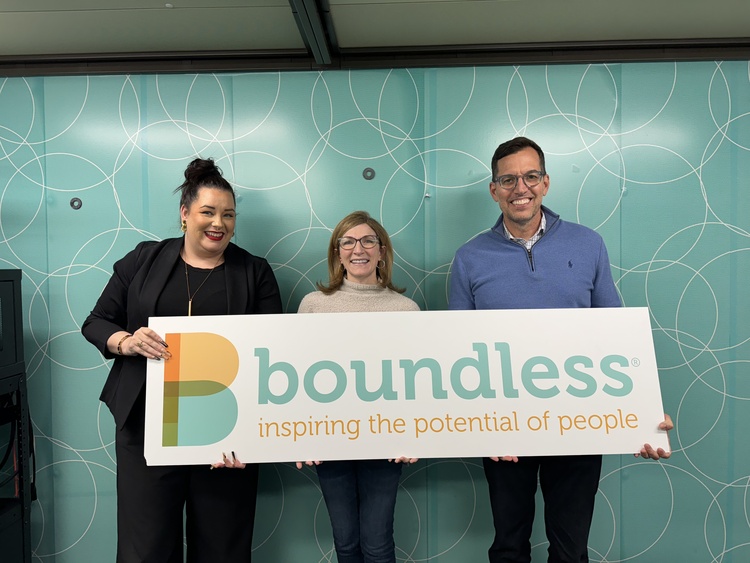 Guests Ana Santos, Julie and host Scott Light holding Boundless sign